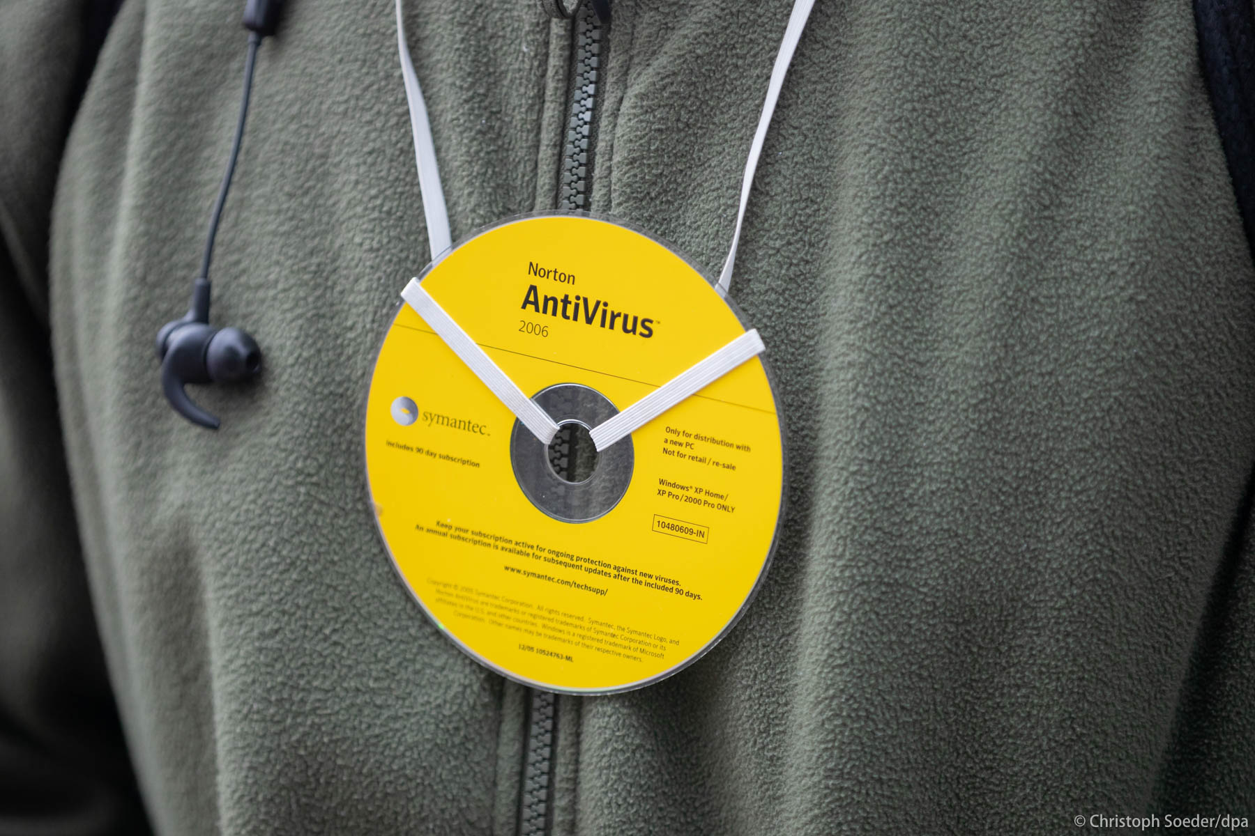A person wearing an anti virus CD around the neck takes part in a protest against coronavirus pandemic regulations in Berlin.