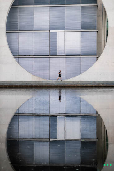 A man walks past the Bundestag building Marie-Elisabeth-Lüders-Haus