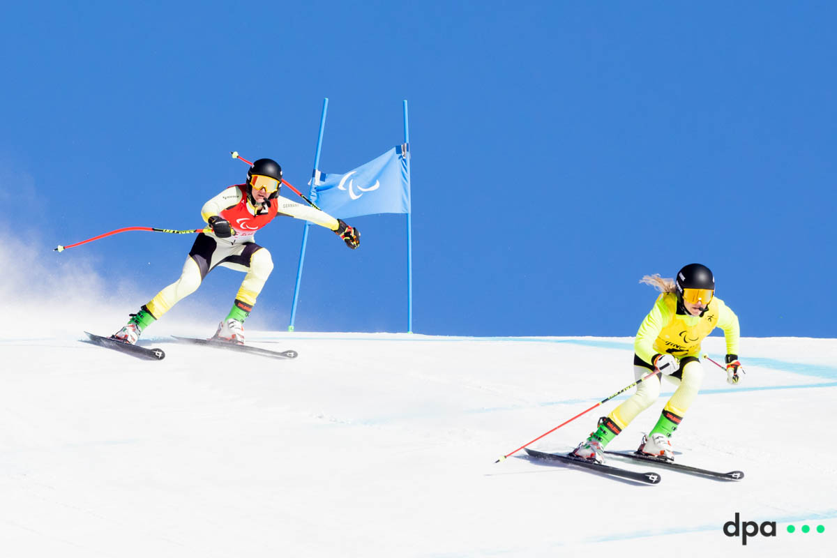 Noemi Ewa Ristau (l) of Germany and guide Paula Elia Brenzel compete in the women's super combination, vision impaired.