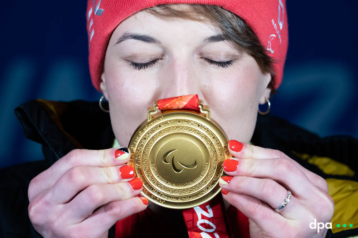 Anna-Lena Forster of Germany kisses her gold medal for the women’s slalom, sitting.