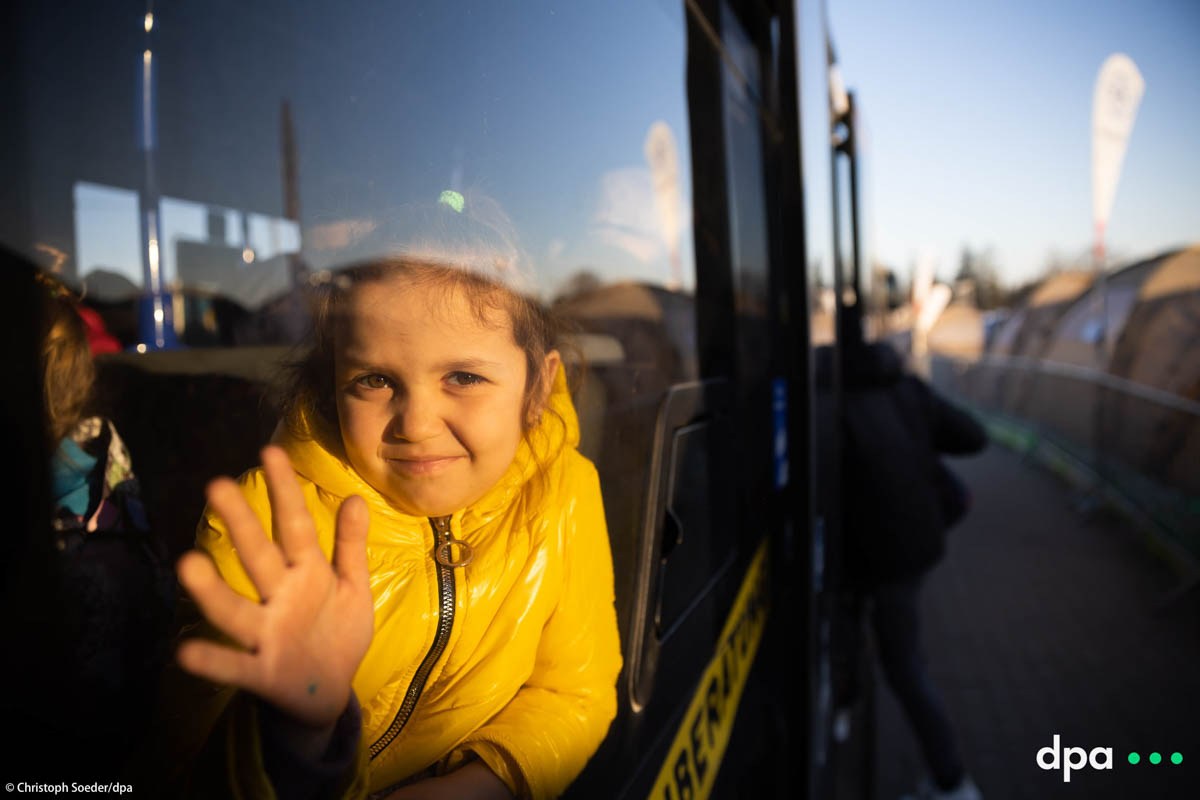A girl waits at the Ukrainian-Polish border crossing in Medyka on the polish side inside a bus.
